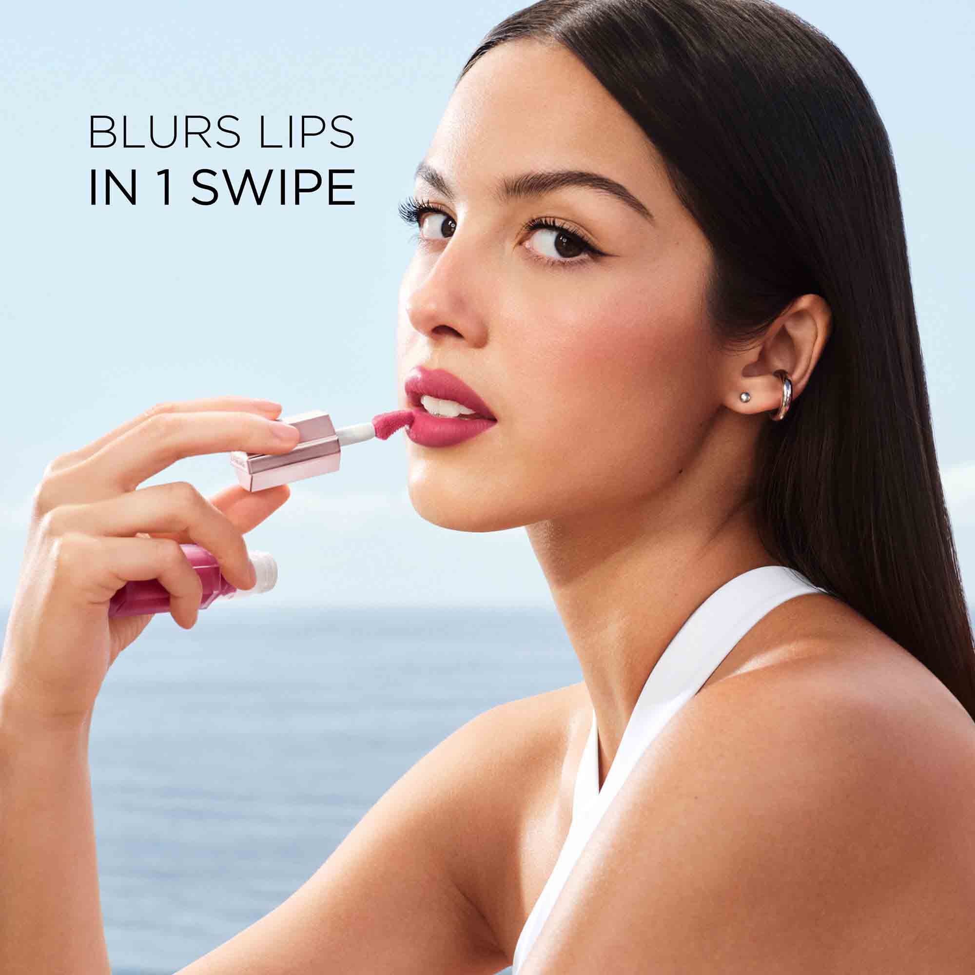 Olivia Rodrigo applying the lipstick