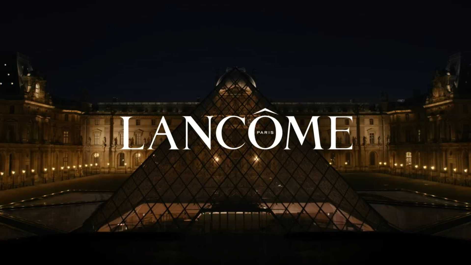 Image promoting the Absolue Skincare Set by Lancome, featuring a glamorous night event at Le Louvre with luxurious presentation